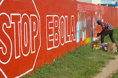 A work of art for educating about Ebola virus disease emerges on the wall at a sports field in Monrovia, paid for by the Liberian Ministry of Health and Social Welfare. Source: Esther Hamblion/WHO
